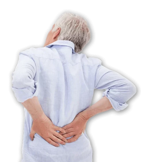 An older individual wearing a light blue shirt is shown from the back, holding the lower back with both hands, suggesting discomfort or pain in the lumbar region.