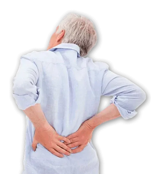 Older individual holding lower back with both hands, indicating discomfort or pain, wearing a light shirt.
